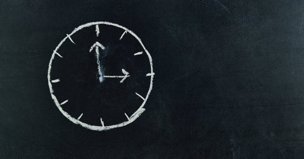Chalk-drawn clock on a blackboard, symbolizing time and education concepts.