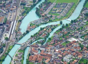 Aerial view of Interlaken, showcasing rivers, bridges, and architecture in Switzerland.