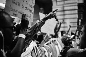 Black and white image of a passionate protest in Torino, capturing unity and expression.
